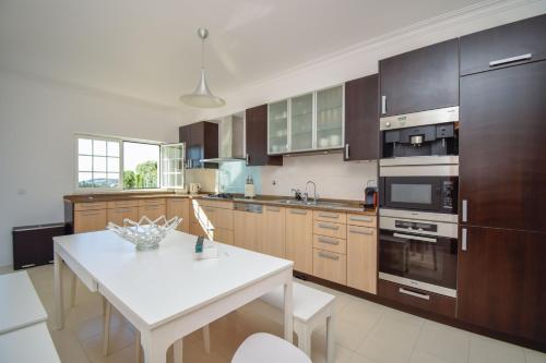 Spacious 4-Bedroom Villa with Private Heated Pool in Quinta da Beloura Sintra Ideal for Families & L in Penha Longa