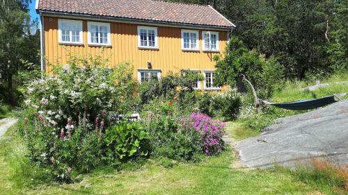 Large house with sea arch, beach and jetty in Høvåg