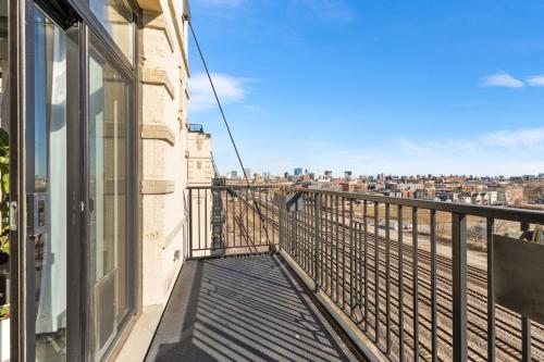 Modern Historic Loft 19ft Ceilings, Gym, Heated Parking, Skyline Views, Balcony in University Village