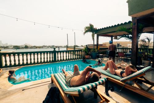 People lounging around a rooftop pool at one of the best hostels in Getsemaní