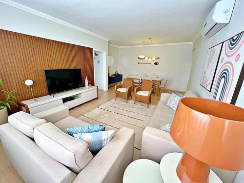 Shared lounge/TV area, Apartamento 100 metros Praia Pitangueiras Guaruja near Restaurante Fogao Caipira