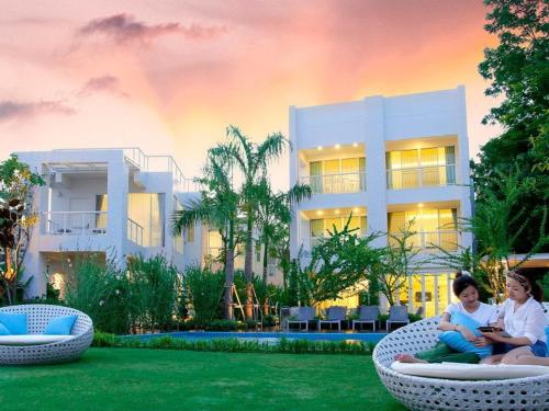 people sitting on a lawn chair in front of a house, Verano Beach Villa in Phetchaburi