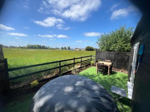 Lavender Lodge - Pool and Hot Tub with sunset views over open fields in Wicklewood