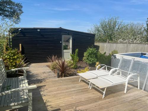 Lavender Lodge - Pool and Hot Tub with sunset views over open fields in Wicklewood