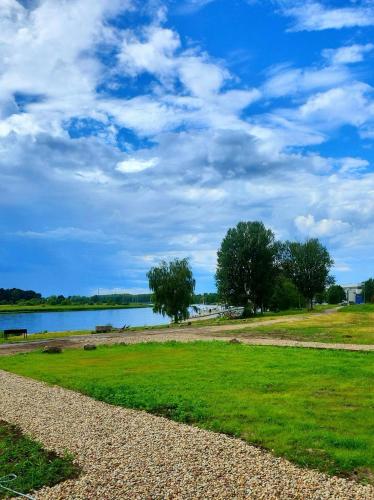 Natura Park Jurmala campsite with tent sites near a river in เจอร์มาลา