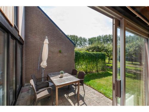 Balcony/terrace, Holiday Home in De Punt with Pool  Garden in Hogeweg