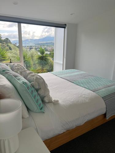 Highhaven on Quebec, sunny hillside, central Nelson hideaway with city to sea views in Washington Valley
