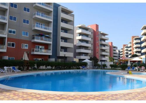 Swimming pool, Elegant 1BR - Al Reef Urban Haven in Abu Dhabi International Airport