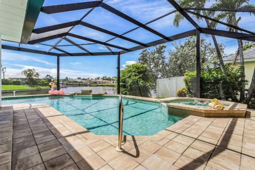 Riverfront Luxury with Heated Pool, Spa & Private Dock - Sunny Shores Escape