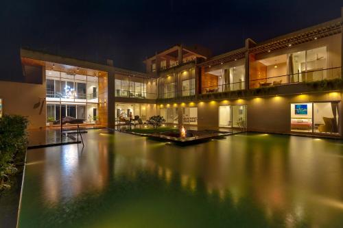 Exterior view of SaffronStays Grand Odyssy - 4BR luxury pool villa with sauna, game zone & lawn, perfect for weddings