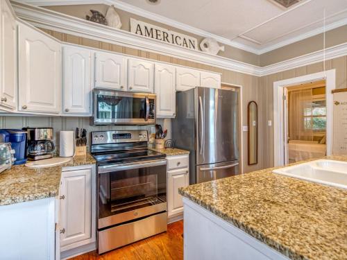New Vacation Home! Heated Pool Access Walk to Beach Restaurants Shopping & More! - image 2