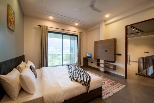 SaffronStays Pebble House - 3BR riverside villa with glass walls, terraces & Nun River views, Dehrad in Galajwari