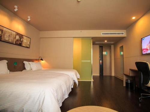 a bedroom with a bed and a television, Jinjiang Inn Wuhan Guanggu Avenue Lingjie Road Branch in Wuhan