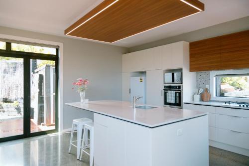 Kitchen, Sunny and Modern Nelson Retreat with Designer Kitchen in Stoke