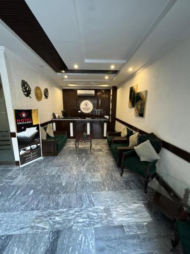 Shared lounge/TV area, Hotel Crescent in Peshawar