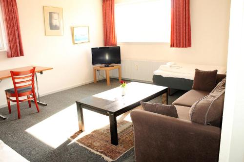 ห้องส่วนกลางสำหรับนั่งเล่น/ดูทีวี, Medio Apartments in เฟรเดอริเซีย