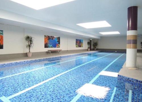 Modern 2BR Stay near Olympic Park with Pool Gym Parking - image 13