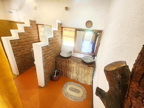 zahrada, Hornbill Bush Lodge in Paraa