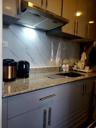 Kitchen, Studio unit with balcony and amenity view near the airport with High speed internet in Cabantian