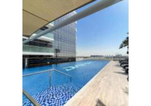 Swimming pool, Yogi – Studio with Pool & Balcony | DAMAC Hills near Dubai Studio City
