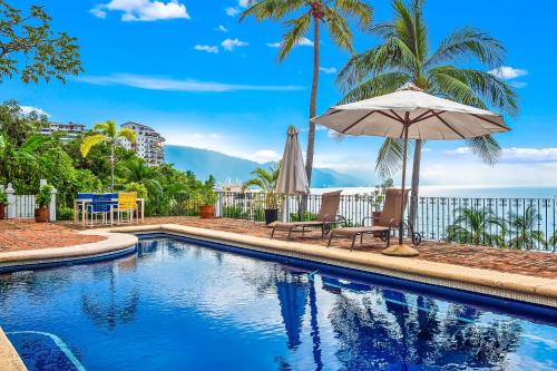 Bright ocean-view 2-story condo near beach with pool, balcony & full kitchen