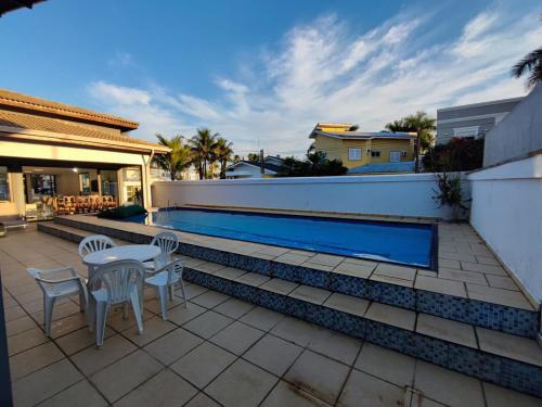 Swimming pool, Casa no cond Acapulco com piscina ate 14 pessoas in Jardim Acapulco