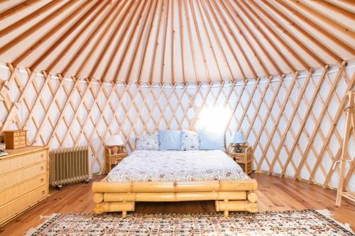 A yurt among olive trees and the sea