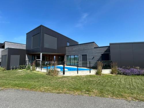 House with pool and steam bath on the beach! in Borhaug