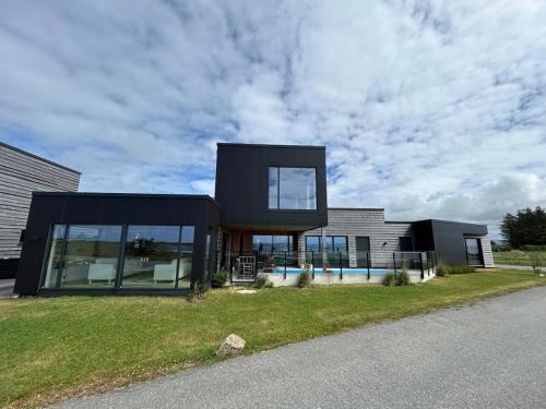 House with pool and steam bath on the beach! in Borhaug