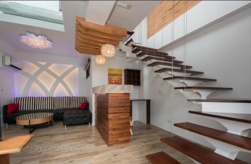 a living room filled with furniture and a staircase, Mou Xia Villa in Yilan