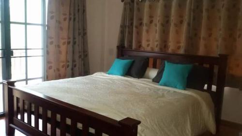 a bed that has a blanket on top of it, Rimtalay Angsila Guesthouse in Chonburi