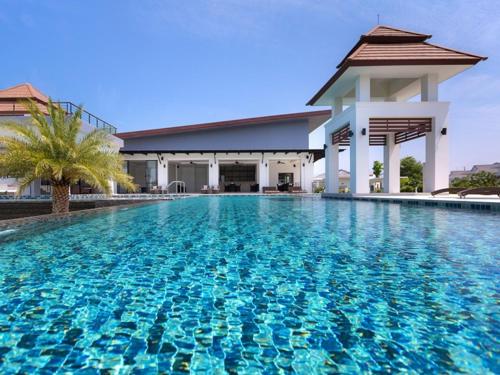 a swimming pool with a blue and white swimming pool, Sea Breeze Pool Villa S126 - free wifi in Hua Hin / Cha-am