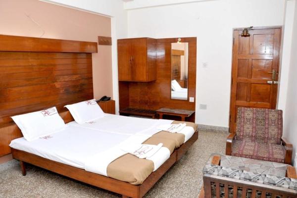 The photo shows the PRANAM COMFORTS LODGE located in the city of Bengaluru.