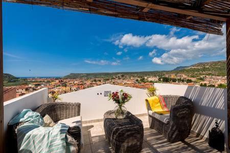 The photo shows the The Tower House with a gorgeous terrace located in the city of Bosa.