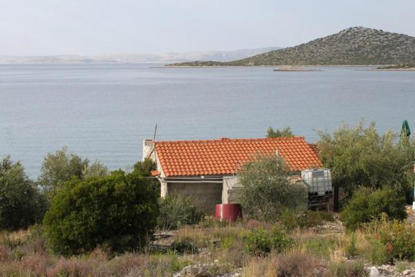 The photo shows the Secluded fisherman's cottage Cove Vitane, Pasman - 8465 located in the city of Tkon.