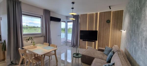 A la foto es mostra l'objecte 62m2 Apartament PREMIUM Łąki i Pola, ELEKTRYCZNE ROLETY, KLIMATYZACJA, GARAŻ, ŁADOWARKA AUT ELEKTRYCZNYCH situat a la ciutat de Suwałki.