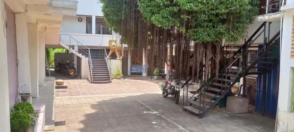 The photo shows the Hotel Lions Den & Lions D Restaurant Bar located in the city of Kombichankulama.
