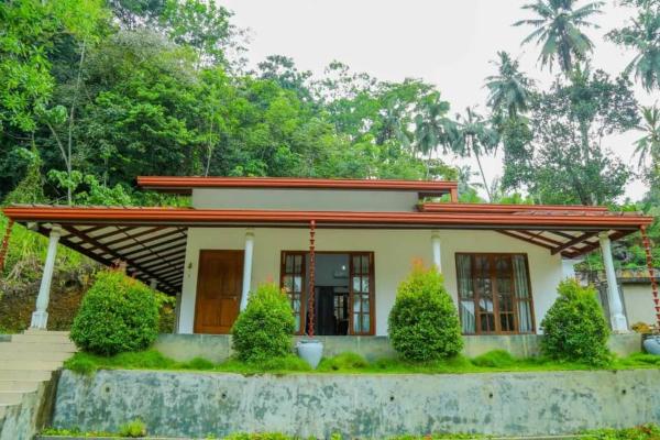 The photo shows the Sinharaja Villa located in the city of Morawaka.