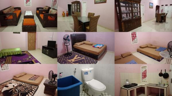 The photo shows the AL IZZAM HOMESTAY located in the city of Pagaralam.