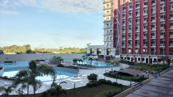 The photo shows the Cozy 1BR Prime World District, Near Airport, Gaisano Grand Mall, Mactan Doctor's Hospital located in the city of Agus.
