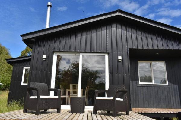The photo shows the Beautiful Don Pedro Cabin, Chilean Patagonia. located in the city of Ayacara.