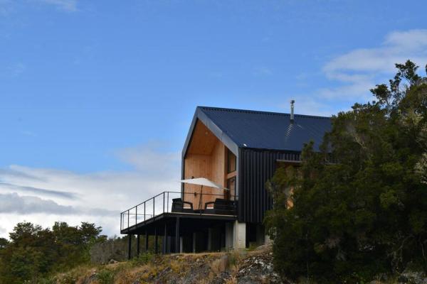 The photo shows the Impressive Don Santiago Cabin, Chilean Patagonia. located in the city of Ayacara.