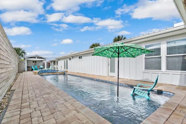 The photo shows the Paradise Packs A Punch! Beachside Home with Heated Pool, Outdoor Lounge, Steps from Beach Access located in the city of St. Augustine.