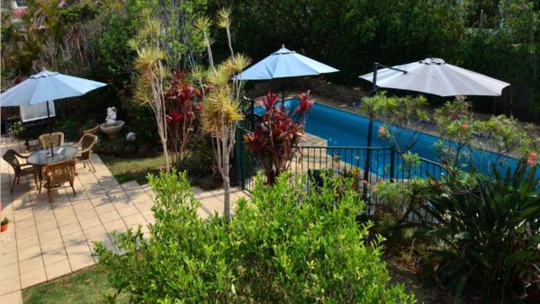 The photo shows the Brellas On The Beach located in the city of Wallabi Point.