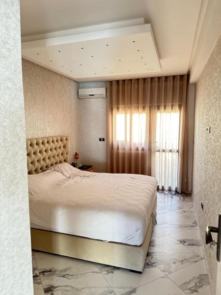 The photo shows the Chambre à Agdal Rabat dans un appartement partagé -king bed- located in the city of Rabat.