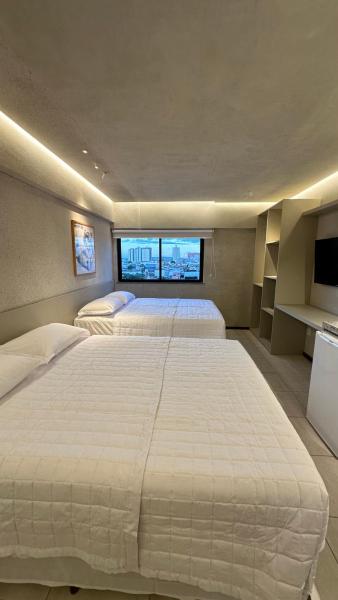 The photo shows the Loft 1 Celita Franca Executive Hotel located in the city of Feira de Santana.