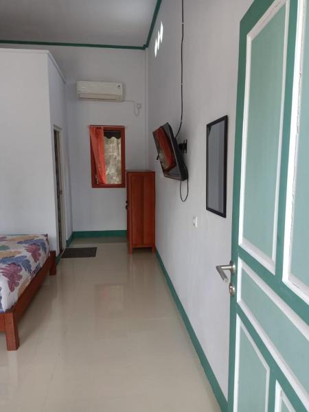 На фото показан объект Tanah merah guest house, расположенный в городе Сингкаванг.