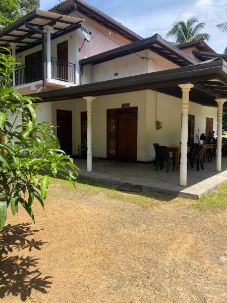 The photo shows the Just Now Inn Sinharaja located in the city of Morawaka.
