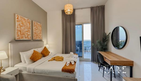 På billedet ses objektet Rare Holiday Homes - Dubai Sports City - Elite Residence - R1303 beliggende i byen Dubai.