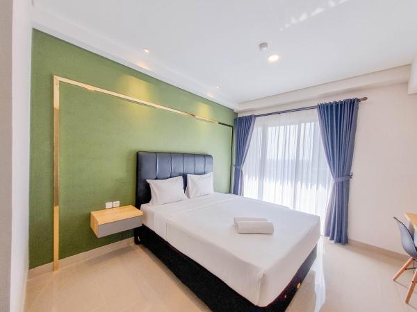 A la foto es mostra l'objecte Homey and Minimalist Studio at Patraland Amarta Apartment By Travelio situat a la ciutat de Kejayan.